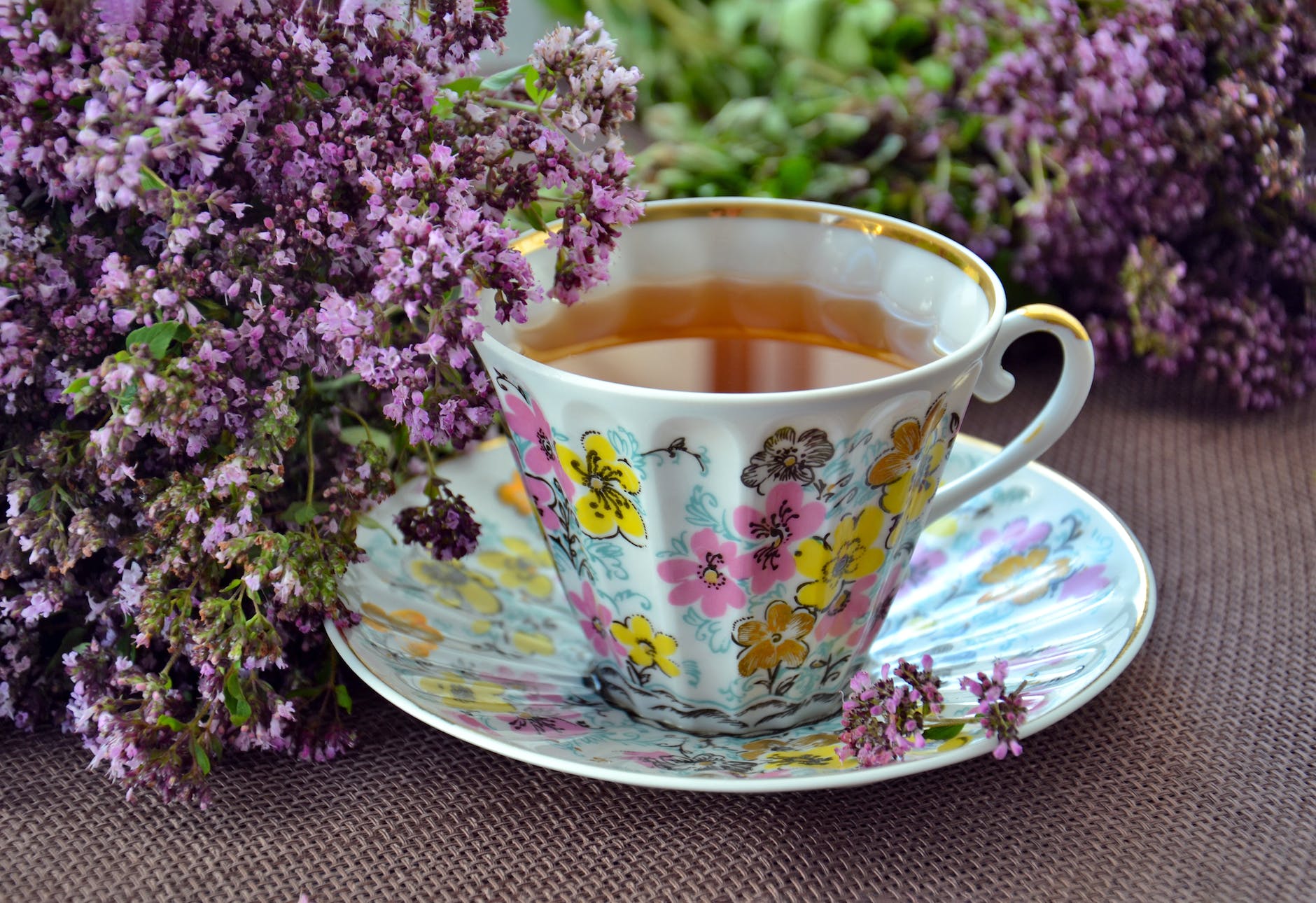 photo of white pink and yellow ceramic mug and saucer