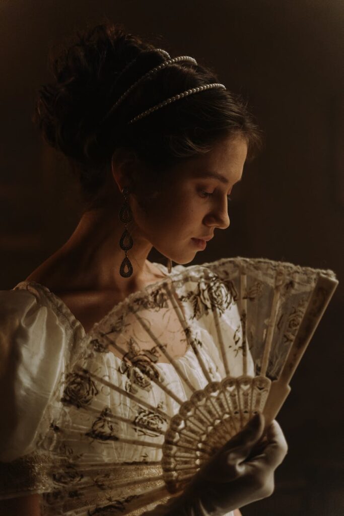 portrait of a woman holding a hand fan